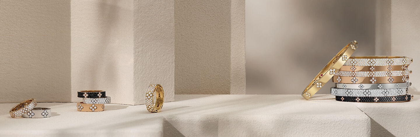 A collection of Roberto Coin rings and stacked bracelets