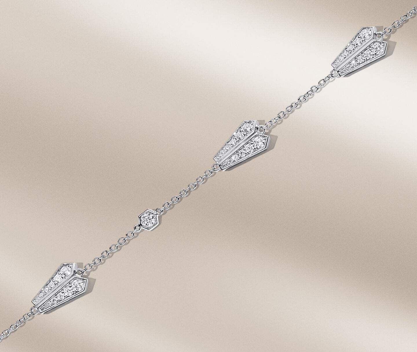 Birks Beekeeper diamond bracelet on a beige background.