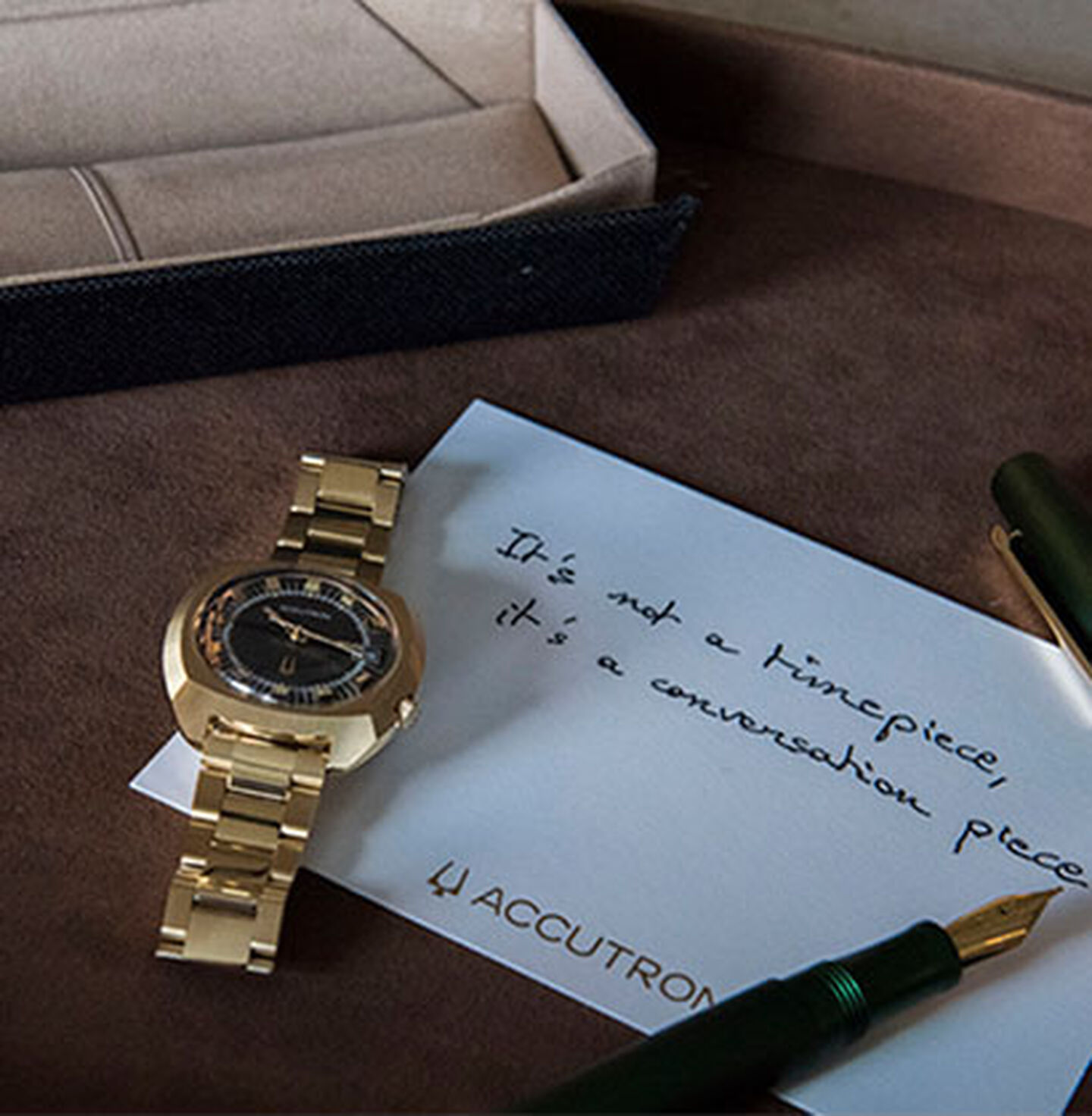 Accutron Legacy watch on a desk with pen and paper