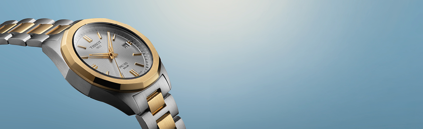 Tissot watch on a blue background.