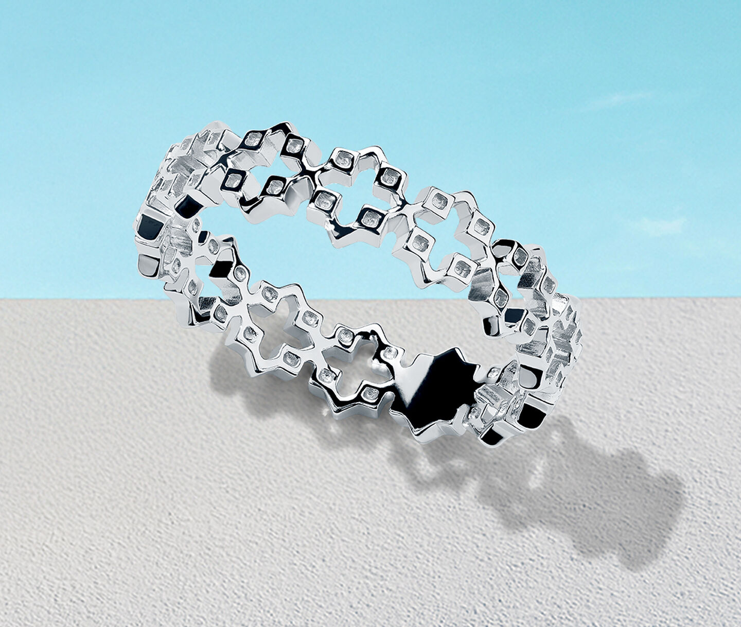 Birks Iconic Muse silver ring on a blue background.