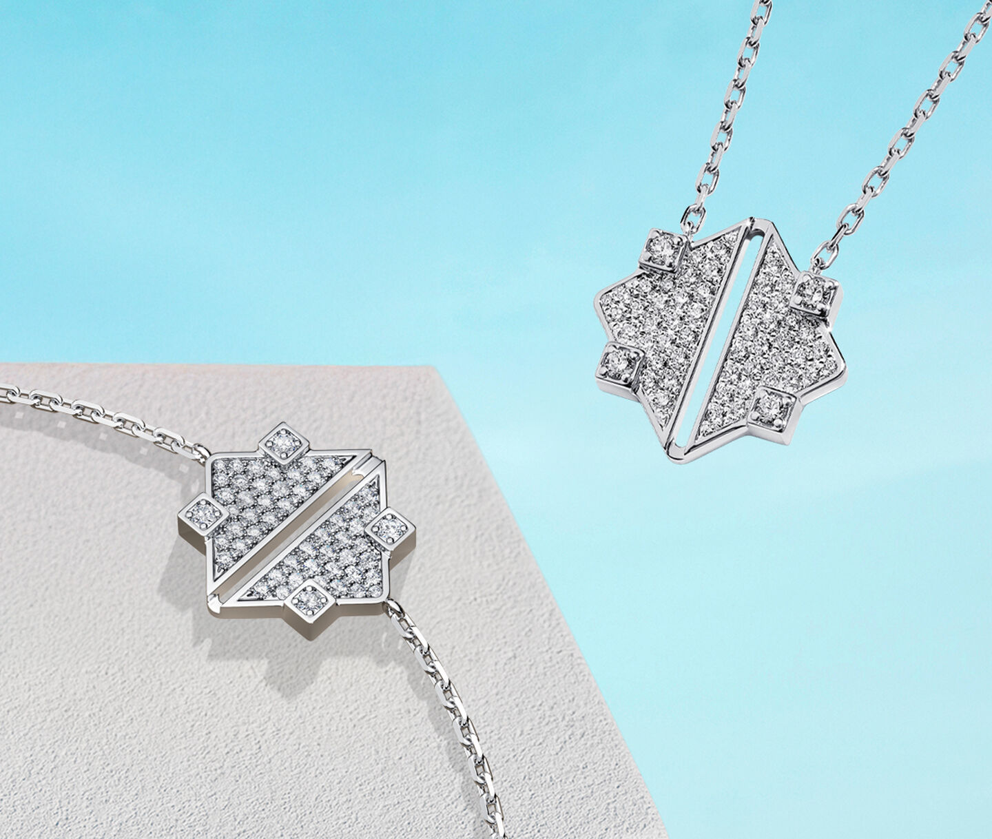 Birks Muse white gold and diamond pendant and bracelet on a blue background.