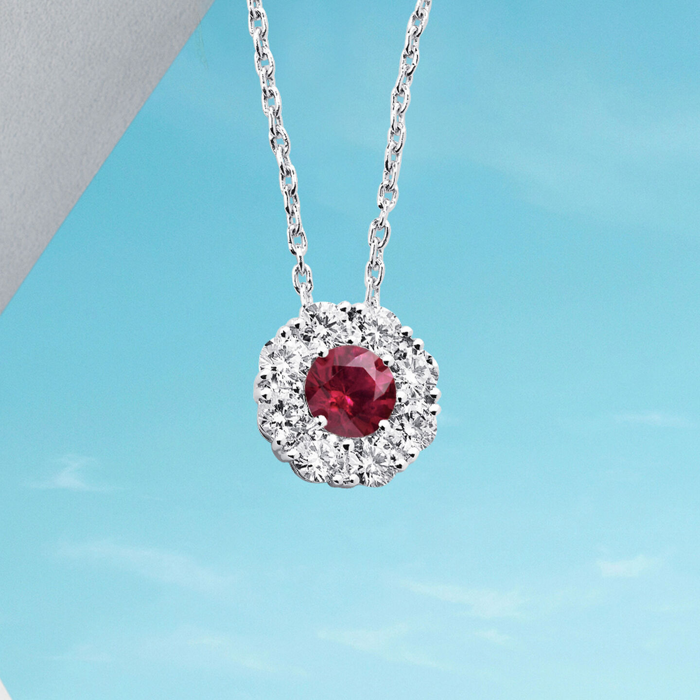 Birks Snow Angel earrings on a blue background.