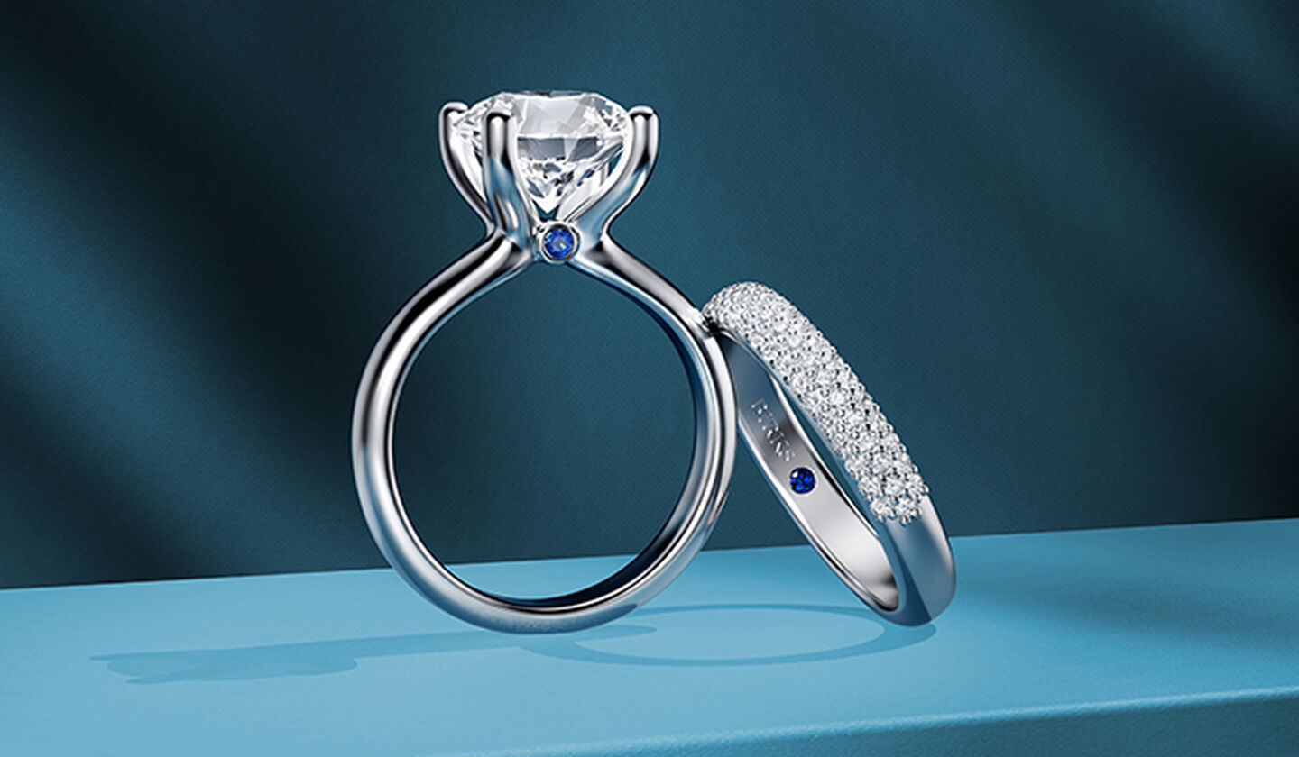 A Birks Blue diamond engagement ring on a blue background.