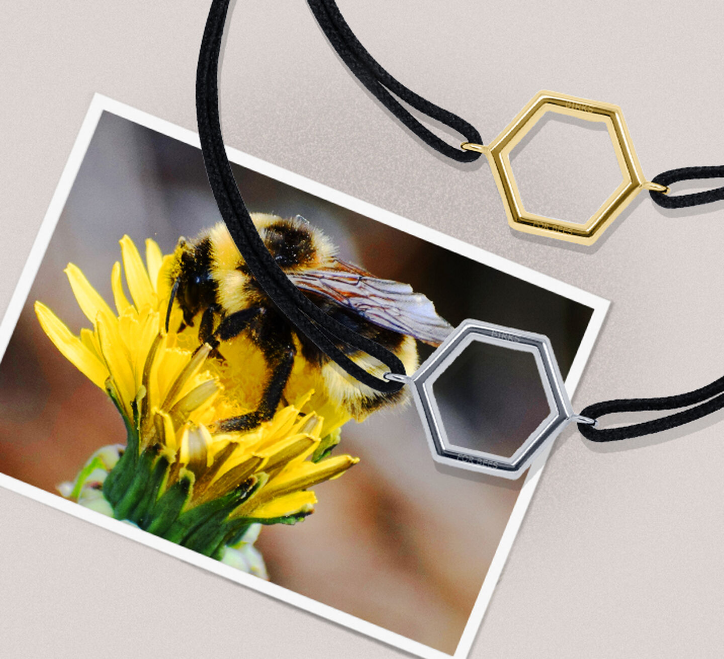 Gold and Silver Hexagonal pendant bracelets sitting on a photo of a bee on a yellow flower