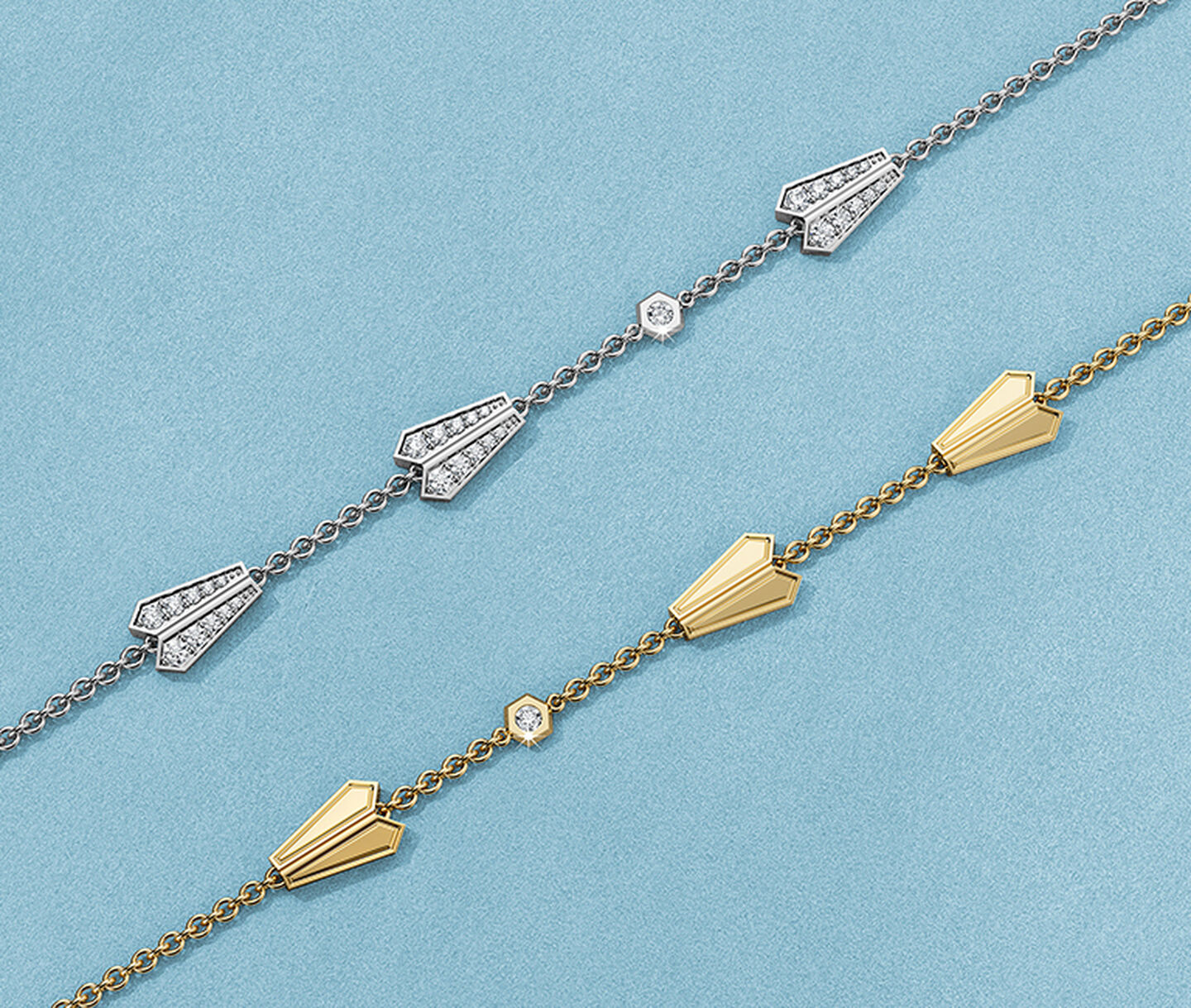 Birks Beekeeper yellow gold and diamond bracelets on a blue background.