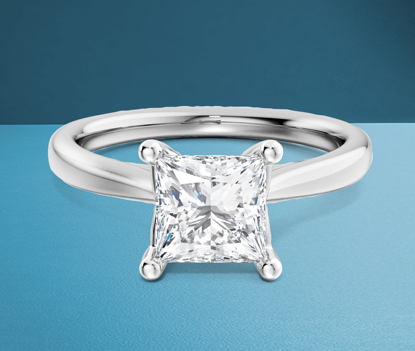 Birks 1879 princess-cut diamond engagement ring on a blue background.