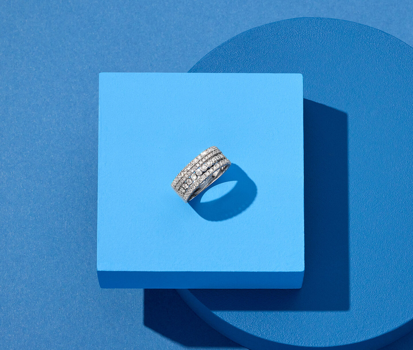 Birks Splash diamond ring on a blue background.