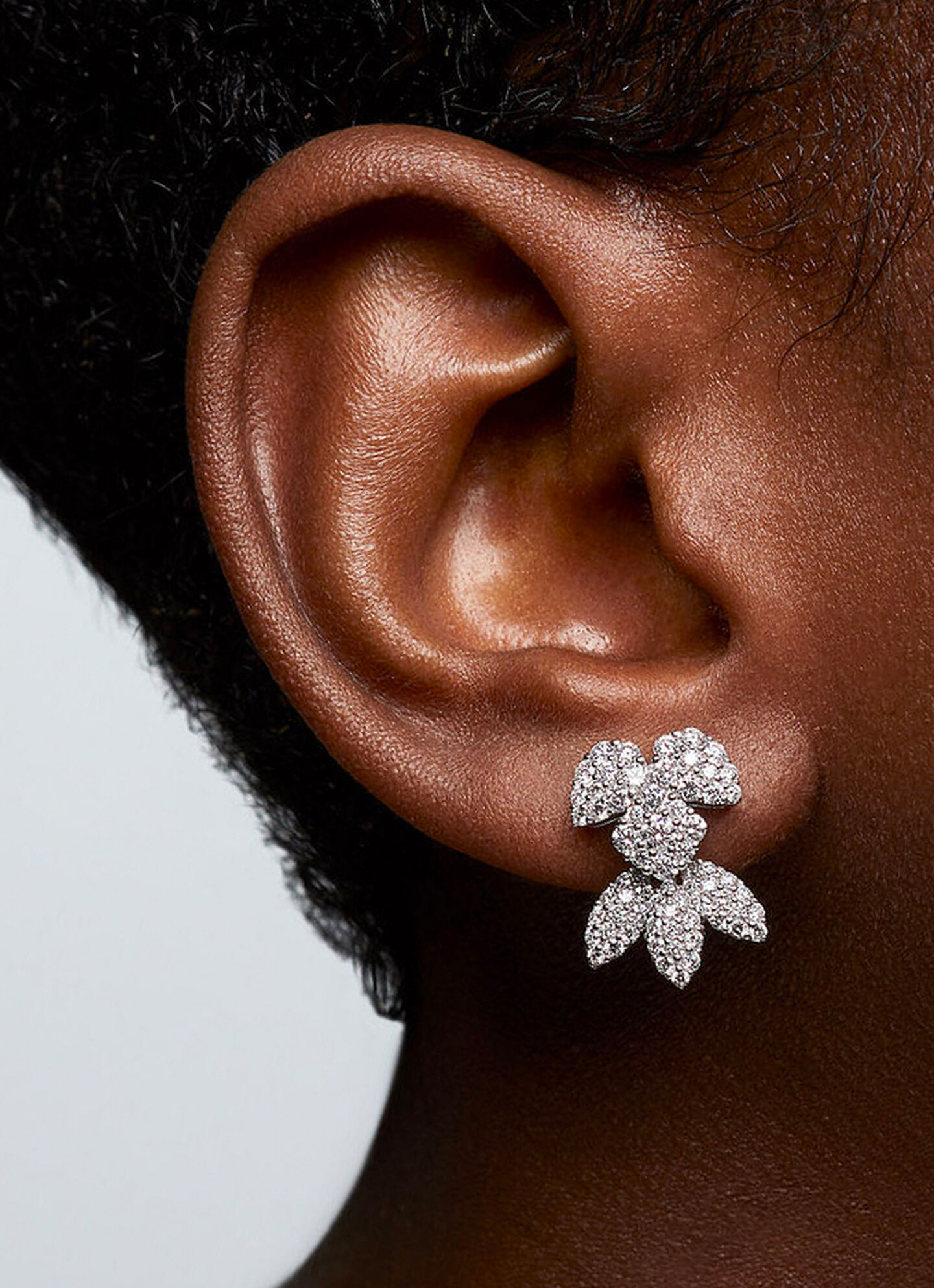 A model wearing Birks Snowflake Snowstorm diamond earrings.