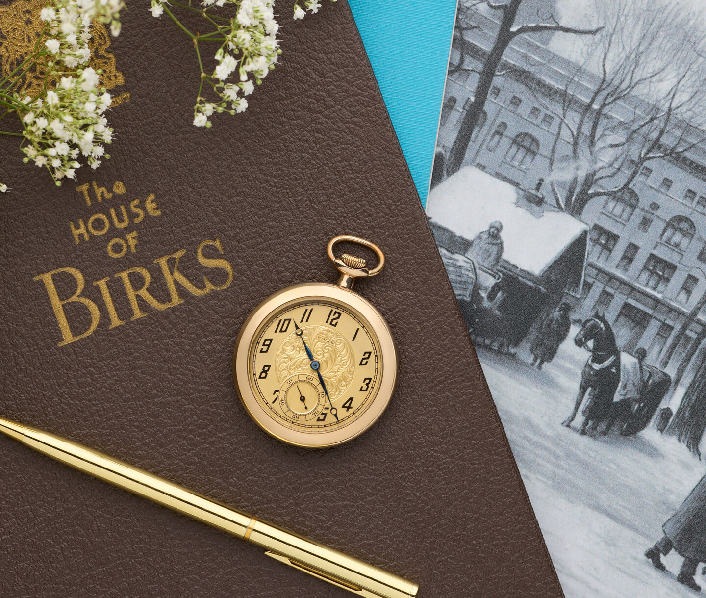 Vintage Birks pocket watch displayed on a House of Birks book, symbolizing family heritage and treasured memories.