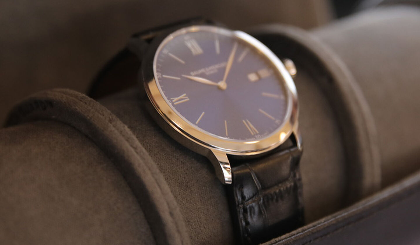 A watch in a WOLF leather watch roll.