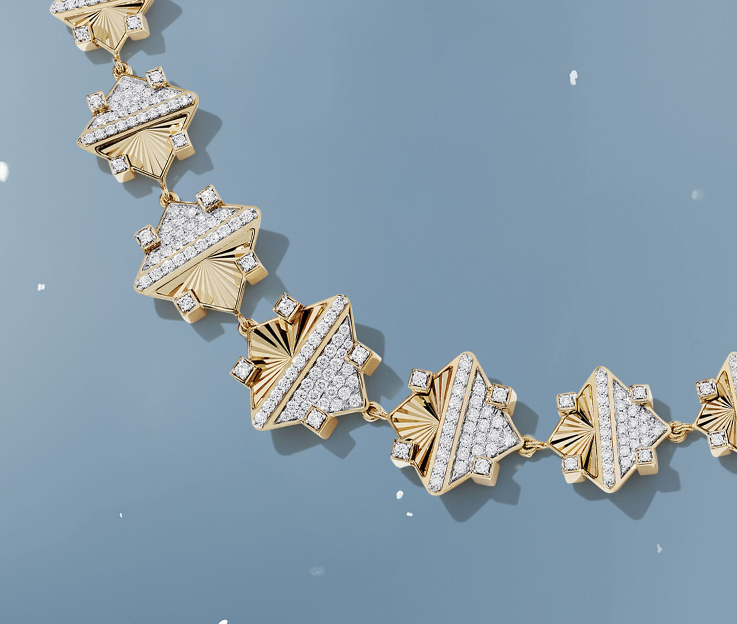 Birks Dare to Dream tri-gold ring on a sky background.