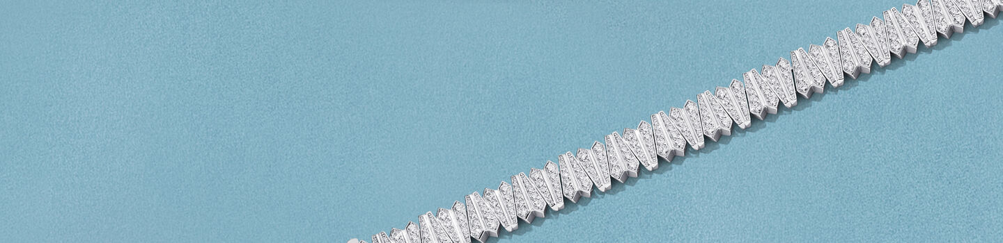 Birks Beekeeper diamond bracelet on a blue background.