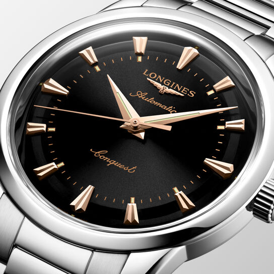 Close-up of black dial with gold hands and round stainless steel case image number 3