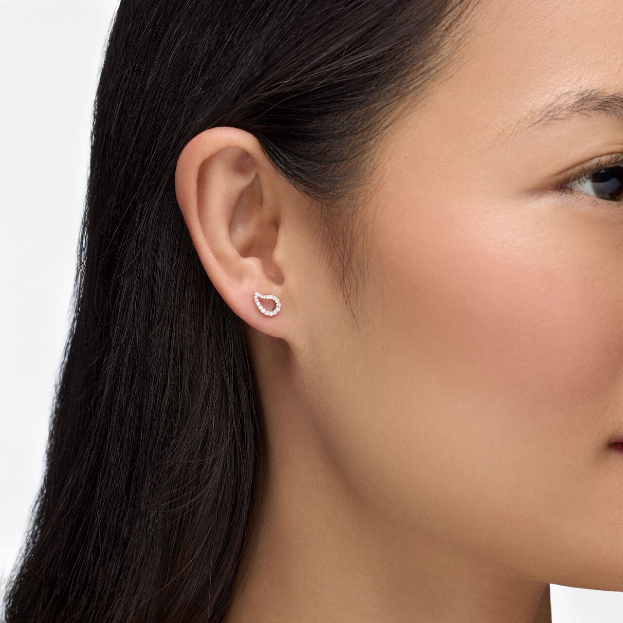 On-model view of Birks P&eacute;tale diamond stud earrings worn on the ear image number 1
