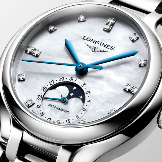 Close-up of moonphase dial with diamond accents and blue hands image number 2