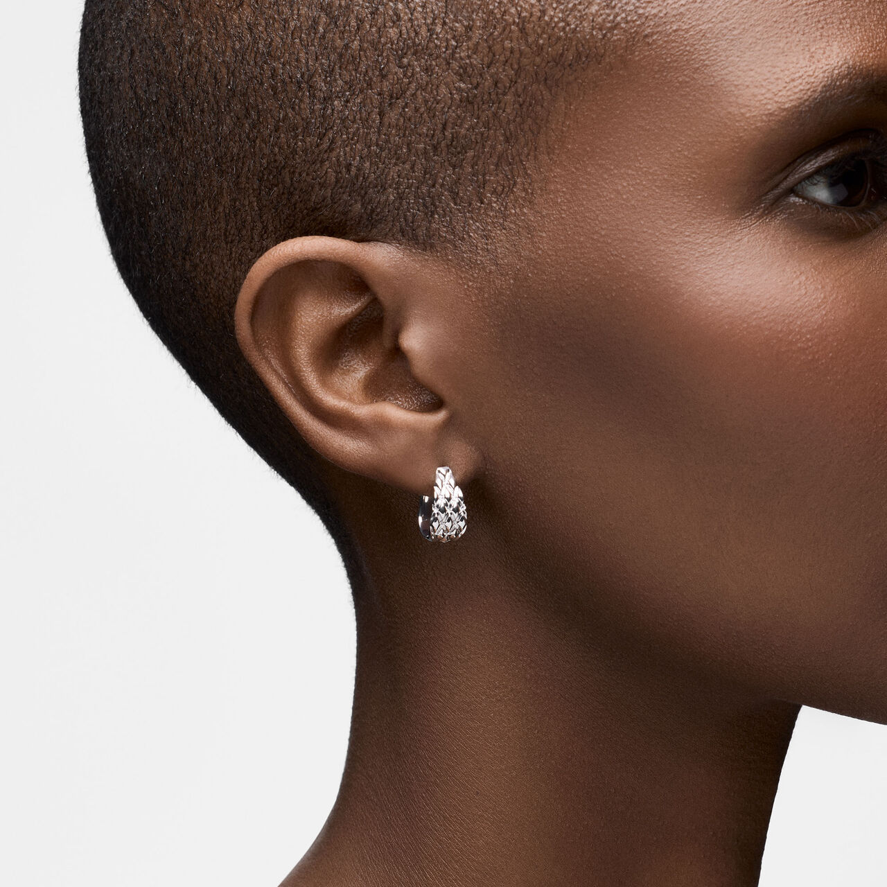 On-model view of Birks Essentials silver serpent hoops worn on the ear image number 1