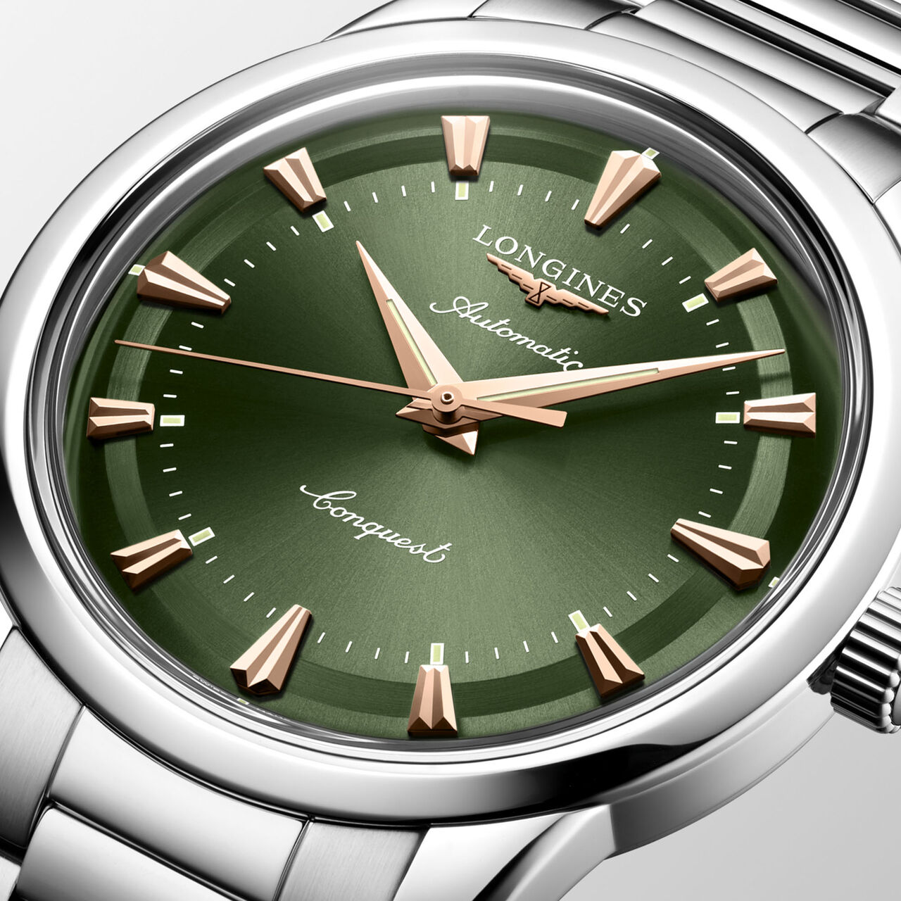 Close-up of olive green dial with gold hands and round stainless steel case image number 2