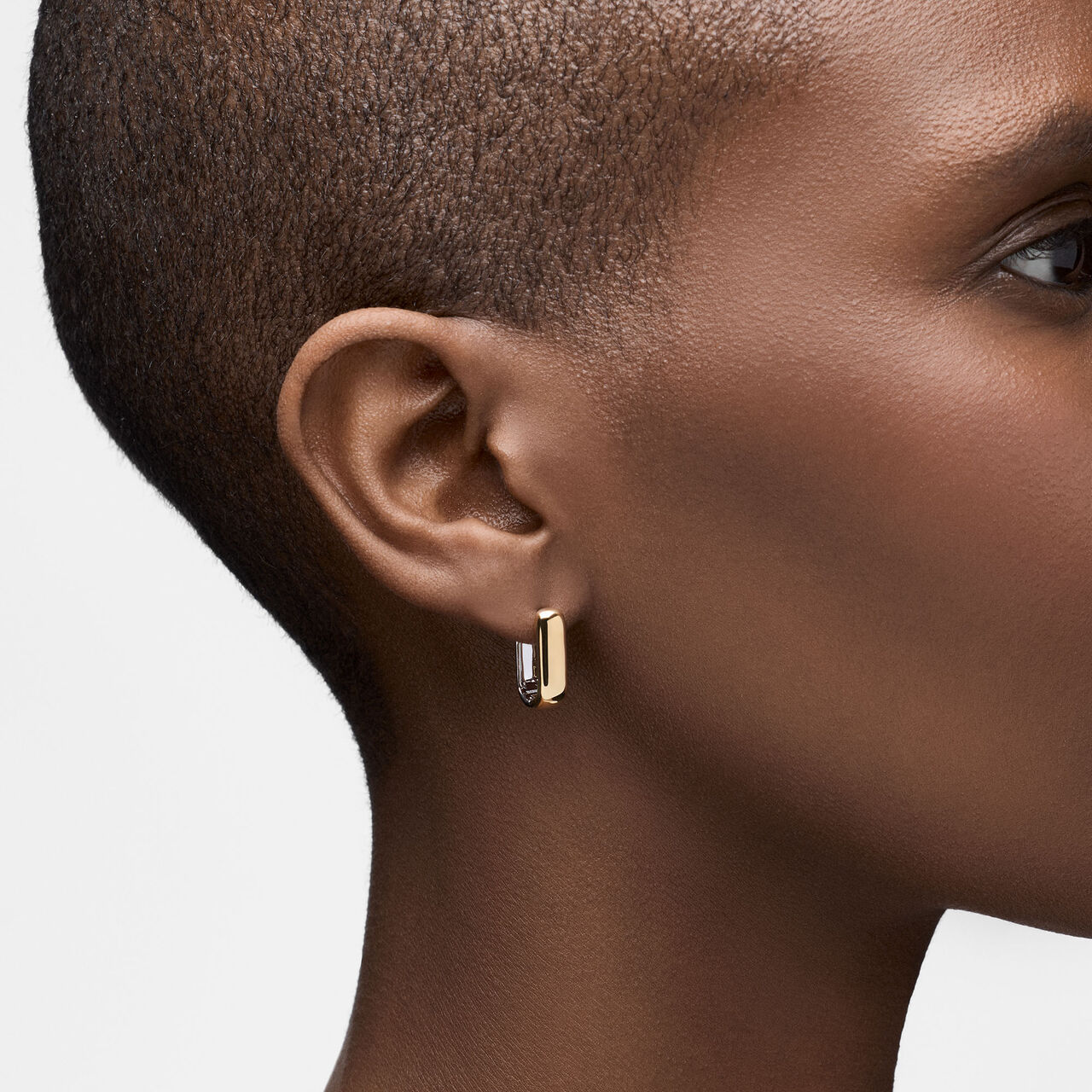 On-model view of Birks Essentials reversed yellow and white gold hoops worn on the ear image number 2