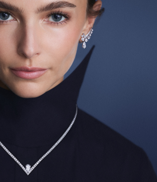 A woman wearing a Chaumet Josephine necklace and earrings